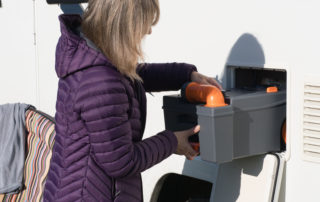 RV owner performing maintenance on RV